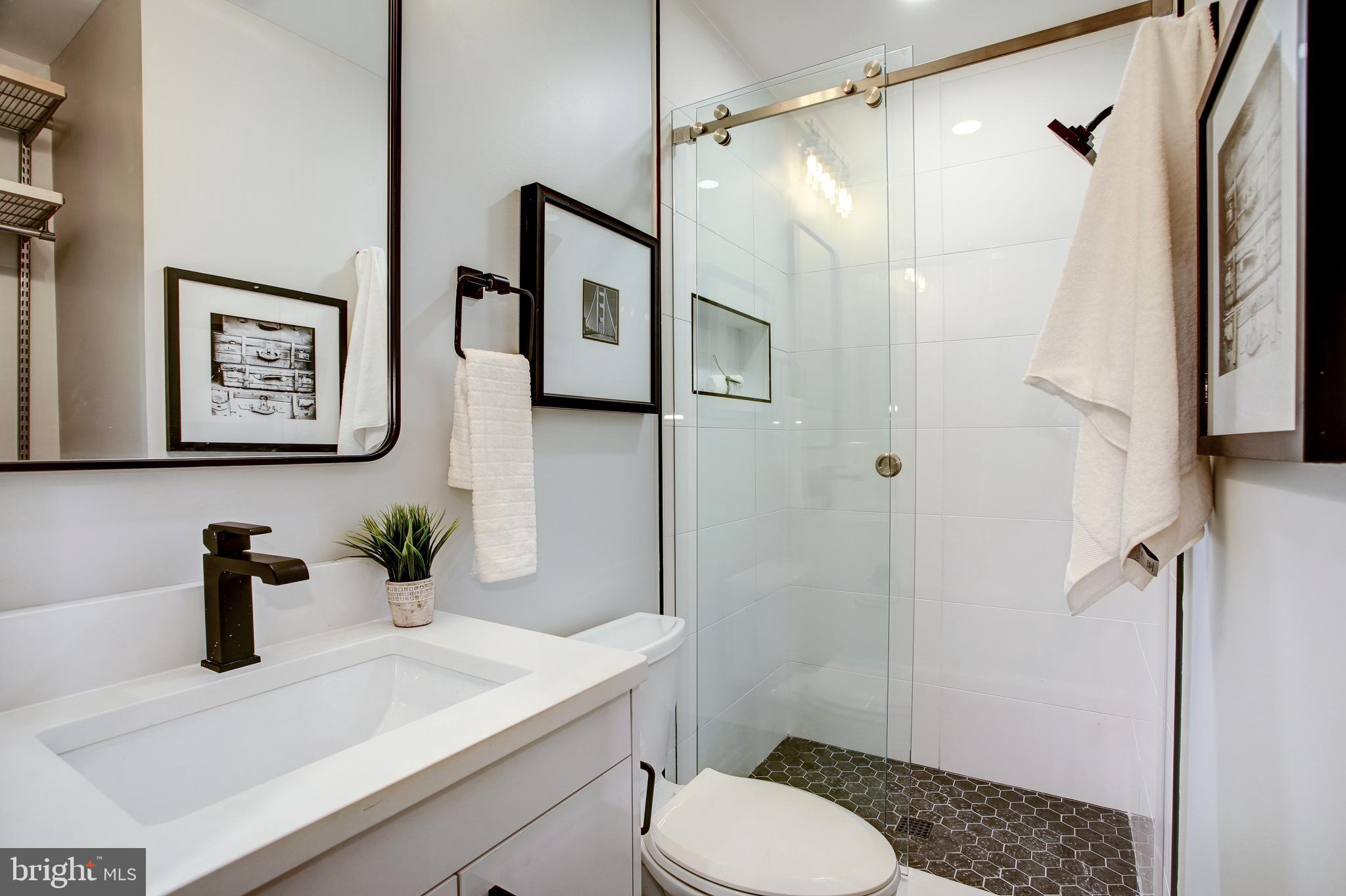 2301 Ontario Road Northwest, Unit 101 Washington, DC 20009 - Photo 20 of 24 a bathroom with a sink toilet and shower