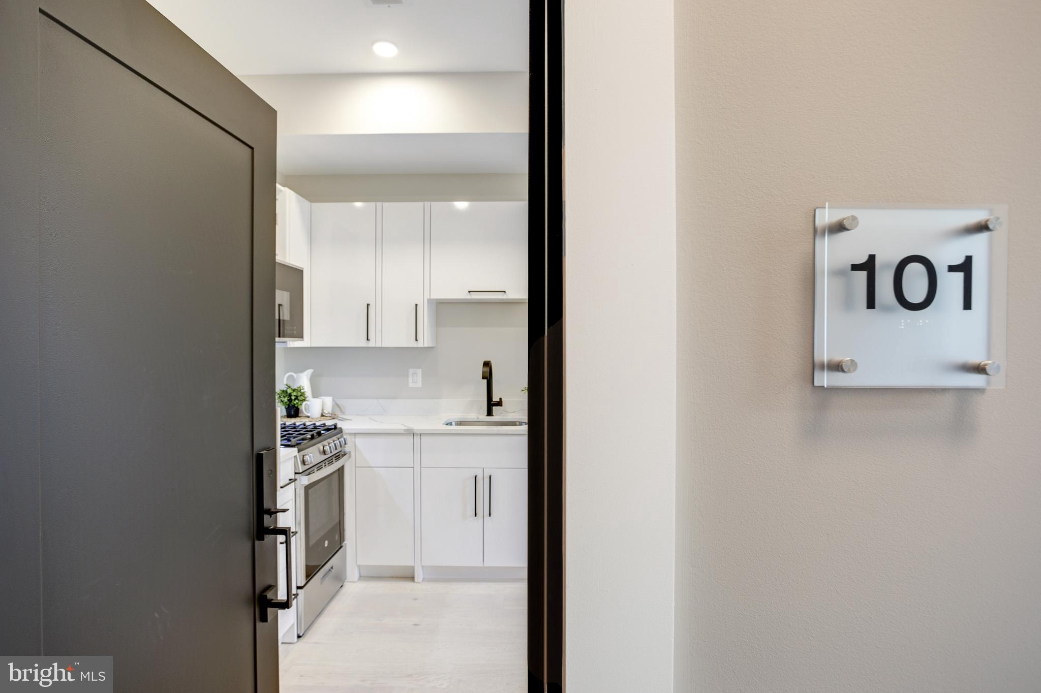 2301 Ontario Road Northwest, Unit 101 Washington, DC 20009 - Photo 2 of 24 a view of cabinets with wooden floor