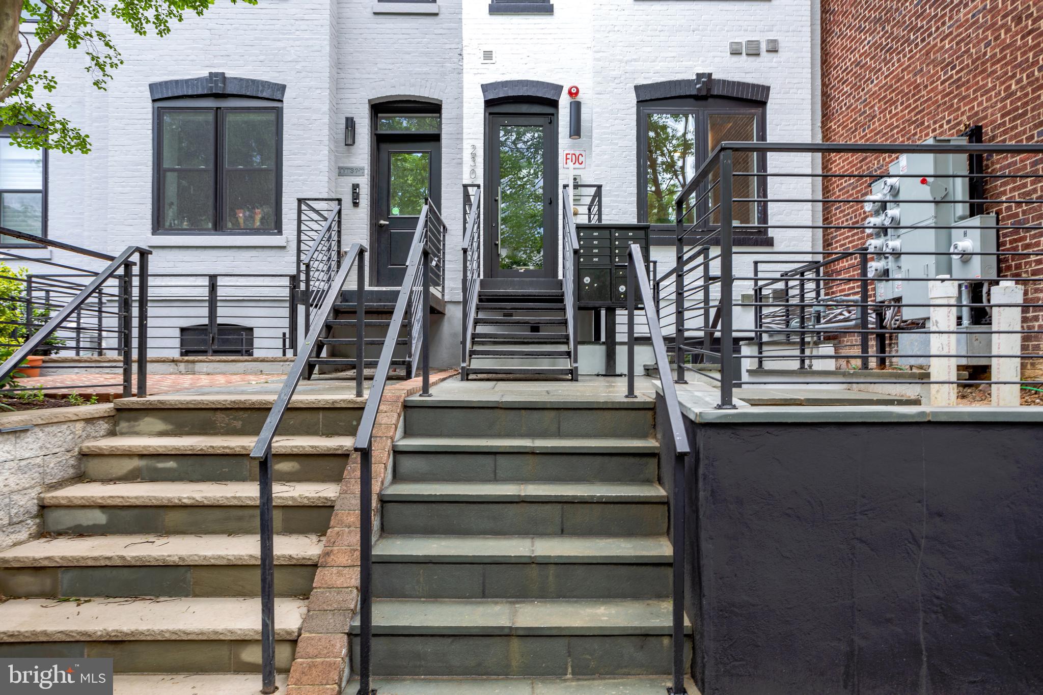 2301 Ontario Road Northwest, Unit 101 Washington, DC 20009 - Photo 22 of 24 a view of staircase with white walls and windows