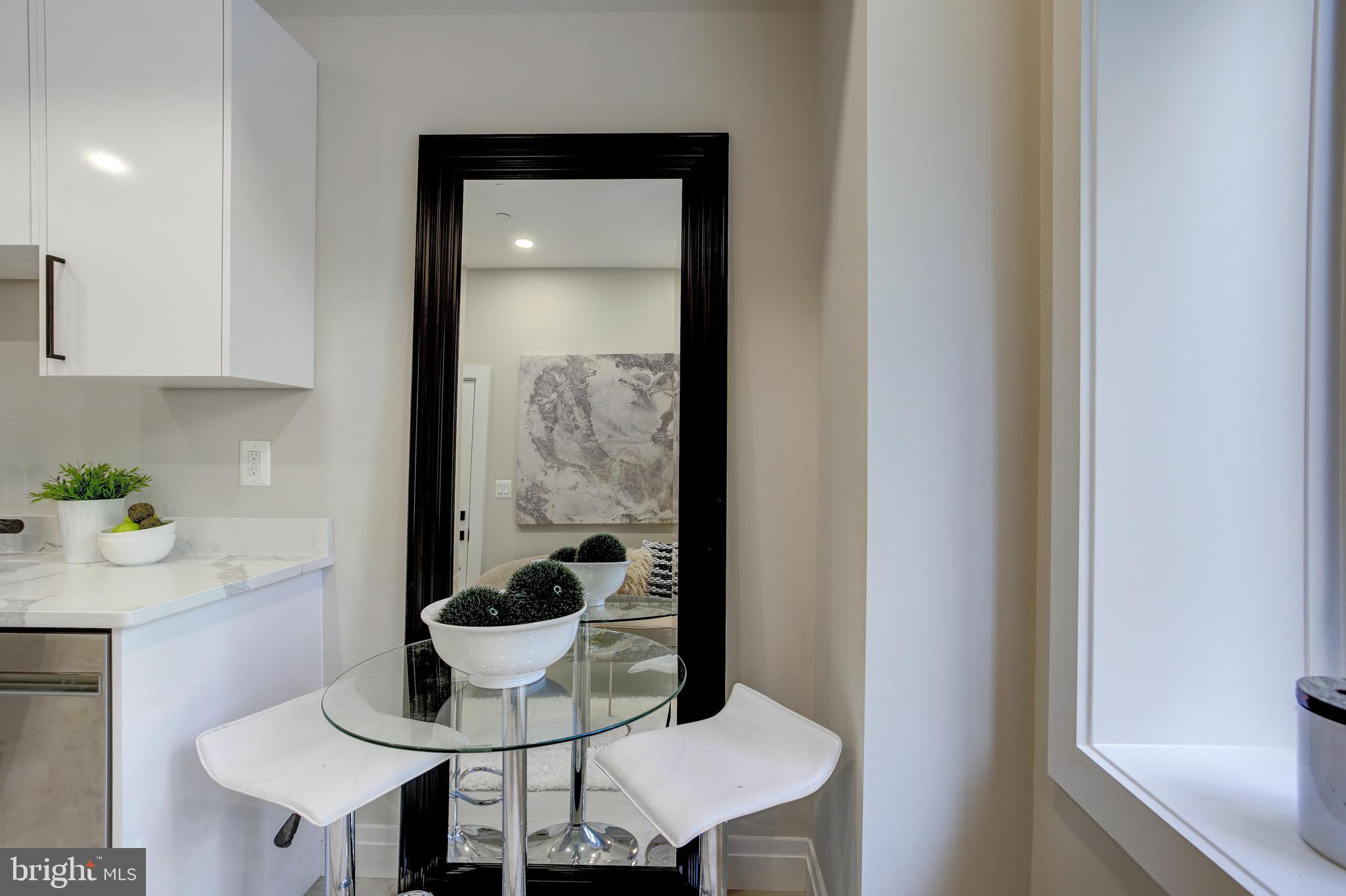 2301 Ontario Road Northwest, Unit 101 Washington, DC 20009 - Photo 4 of 24 a kitchen with a table and a stove