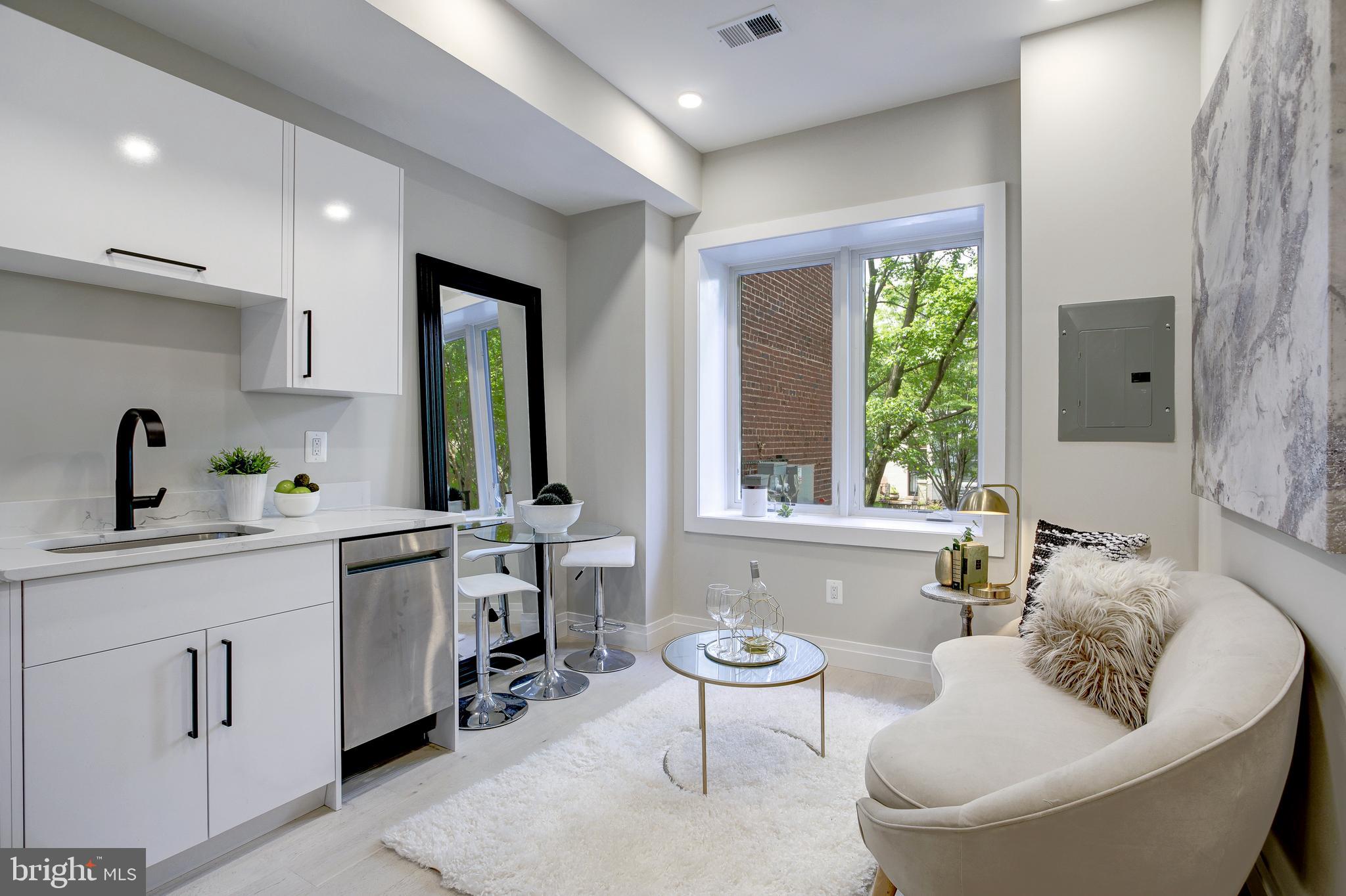 2301 Ontario Road Northwest, Unit 101 Washington, DC 20009 - Photo 9 of 24 a living room with furniture and a large window