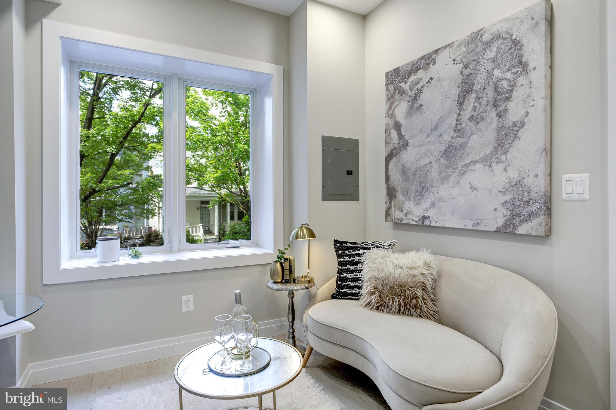 2301 Ontario Road Northwest, Unit 101 Washington, DC 20009 - Photo 10 of 24 a living room with furniture and a large window