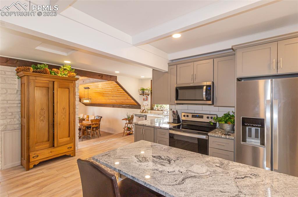 1699 Spring Valley Drive Divide, CO 80814 - Photo 12 of 43 a kitchen with stainless steel appliances granite countertop a refrigerator a stove and a sink