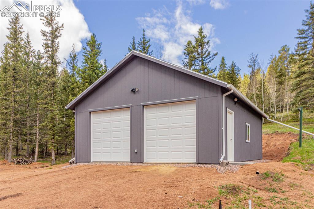 1699 Spring Valley Drive Divide, CO 80814 - Photo 26 of 43 a view of a house with a yard and garage
