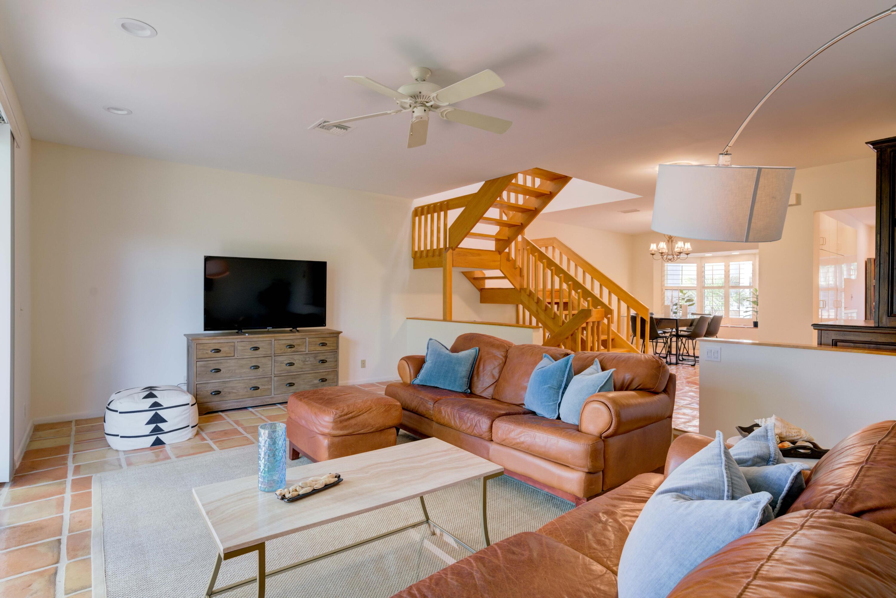 170 Celestial Way, Unit 32 Juno Beach, FL 33408 - Photo 18 of 30 a living room with furniture a flat screen tv and a window