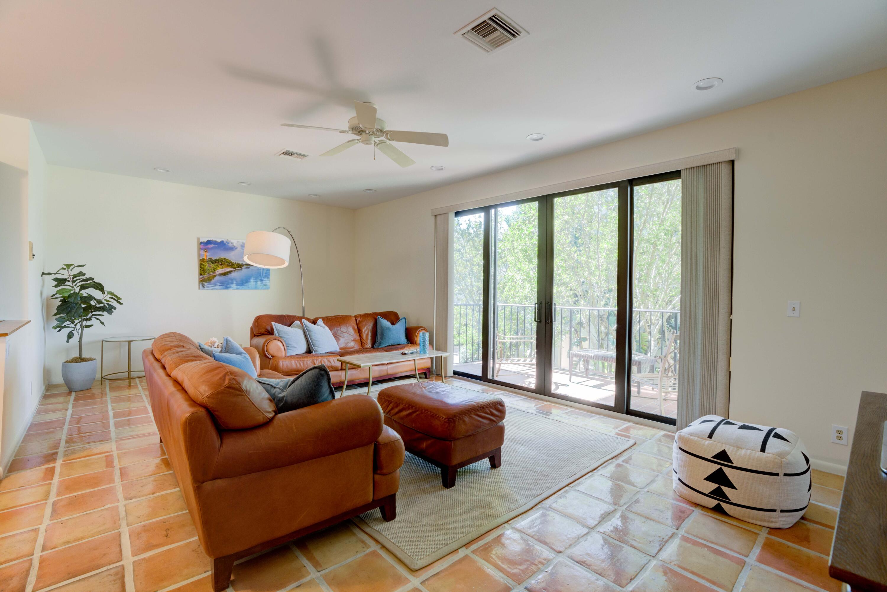 170 Celestial Way, Unit 32 Juno Beach, FL 33408 - Photo 19 of 30 a living room with furniture and a floor to ceiling window