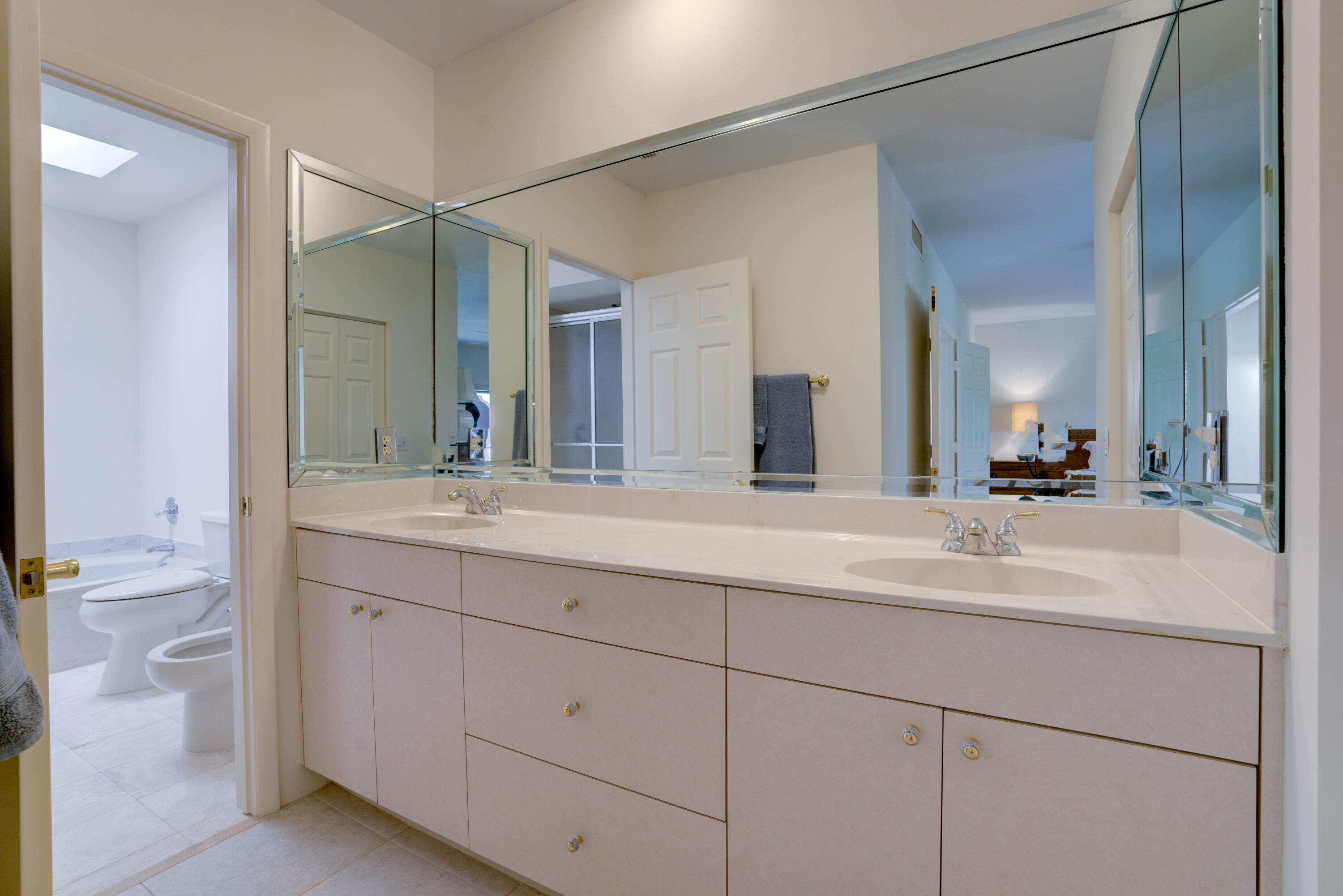 170 Celestial Way, Unit 32 Juno Beach, FL 33408 - Photo 24 of 30 a bathroom with a double vanity sink and a mirror