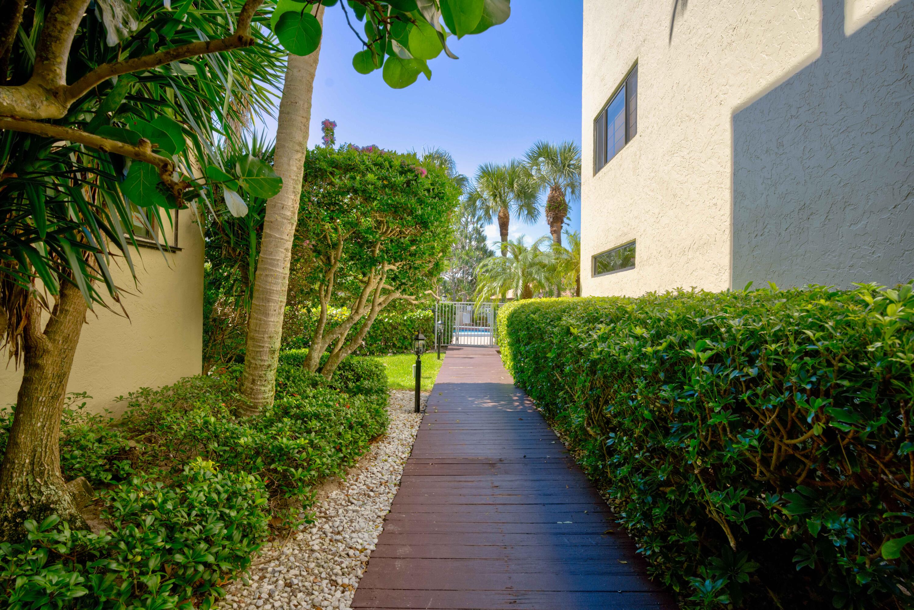 170 Celestial Way, Unit 32 Juno Beach, FL 33408 - Photo 29 of 30 a view of a garden with pathway