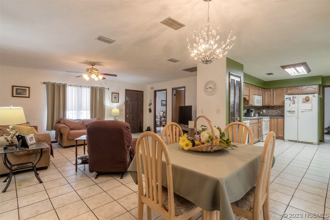 2908 Orange Tree Drive Edgewater, FL 32141 - Photo 13 of 30 a dining room with furniture and chandelier kitchen view