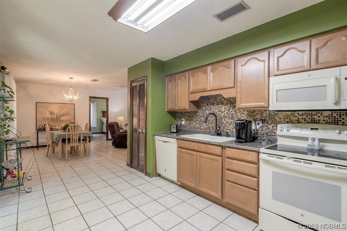 2908 Orange Tree Drive Edgewater, FL 32141 - Photo 16 of 30 a kitchen with stainless steel appliances granite countertop sink cabinets and stove top oven