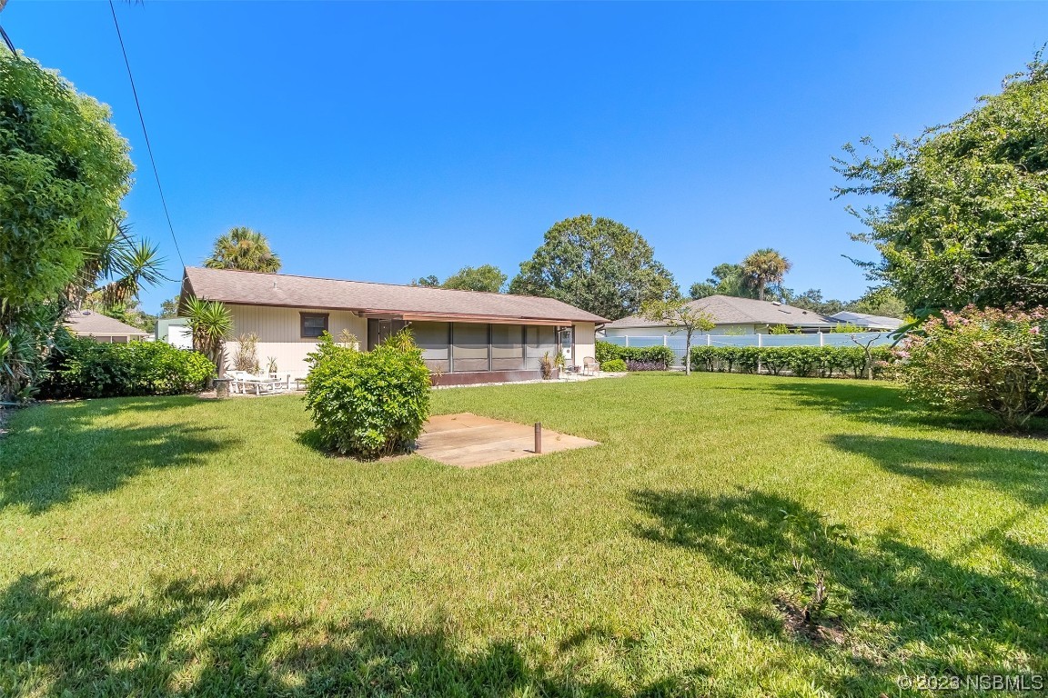 2908 Orange Tree Drive Edgewater, FL 32141 - Photo 23 of 30 a view of house with garden space and trees