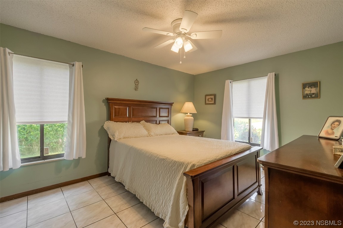 2908 Orange Tree Drive Edgewater, FL 32141 - Photo 4 of 30 a bedroom with a bed and window
