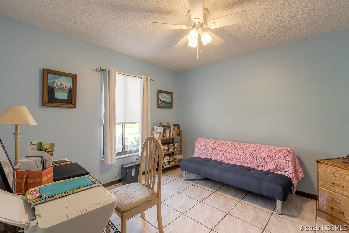 2908 Orange Tree Drive Edgewater, FL 32141 - Photo 7 of 30 a bedroom with a bed and a chandelier