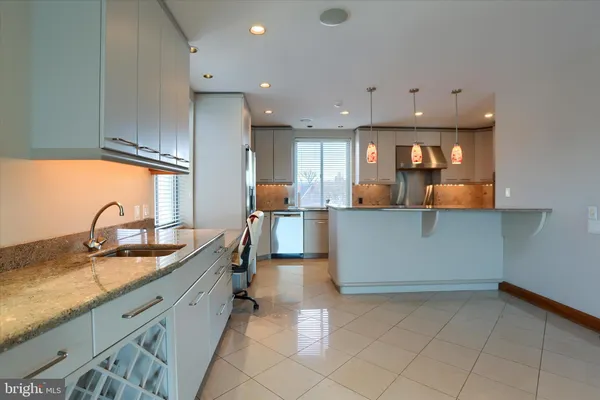 a kitchen with stainless steel appliances granite countertop a sink and cabinets