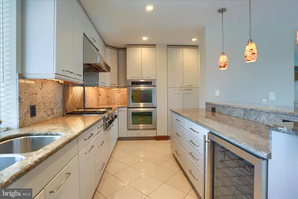 a large kitchen with a stove a sink and a refrigerator