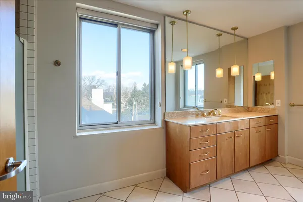 a view of a bathroom with a sink mirror and a shower