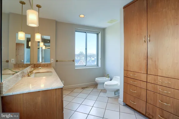 a bathroom with a sink vanity and a toilet