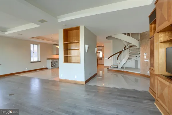 a view of a livingroom with wooden floor and a fireplace