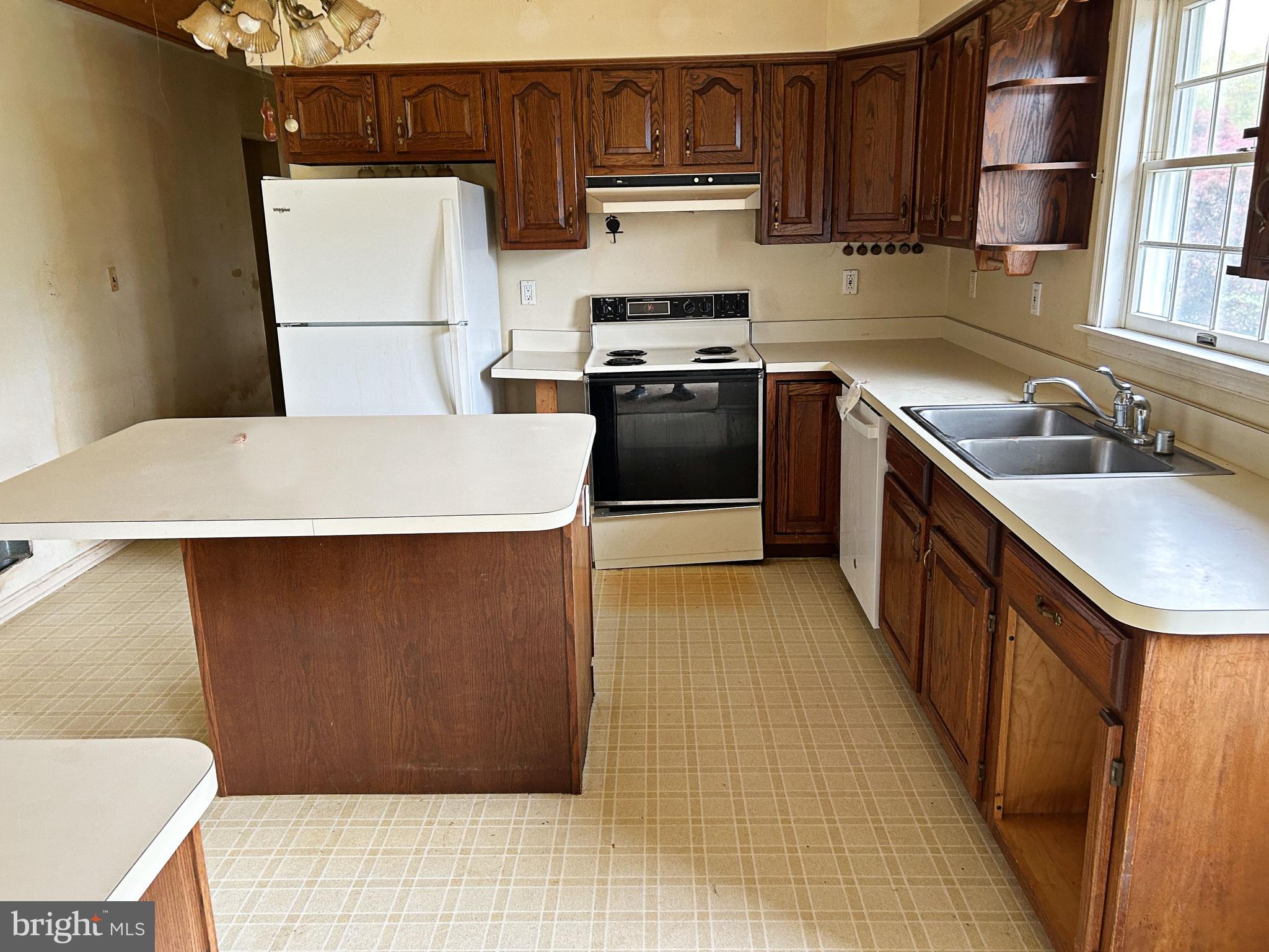 3832 Prospect Road Street, MD 21154 - Photo 8 of 21 a kitchen with a sink a stove top oven a refrigerator and cabinets