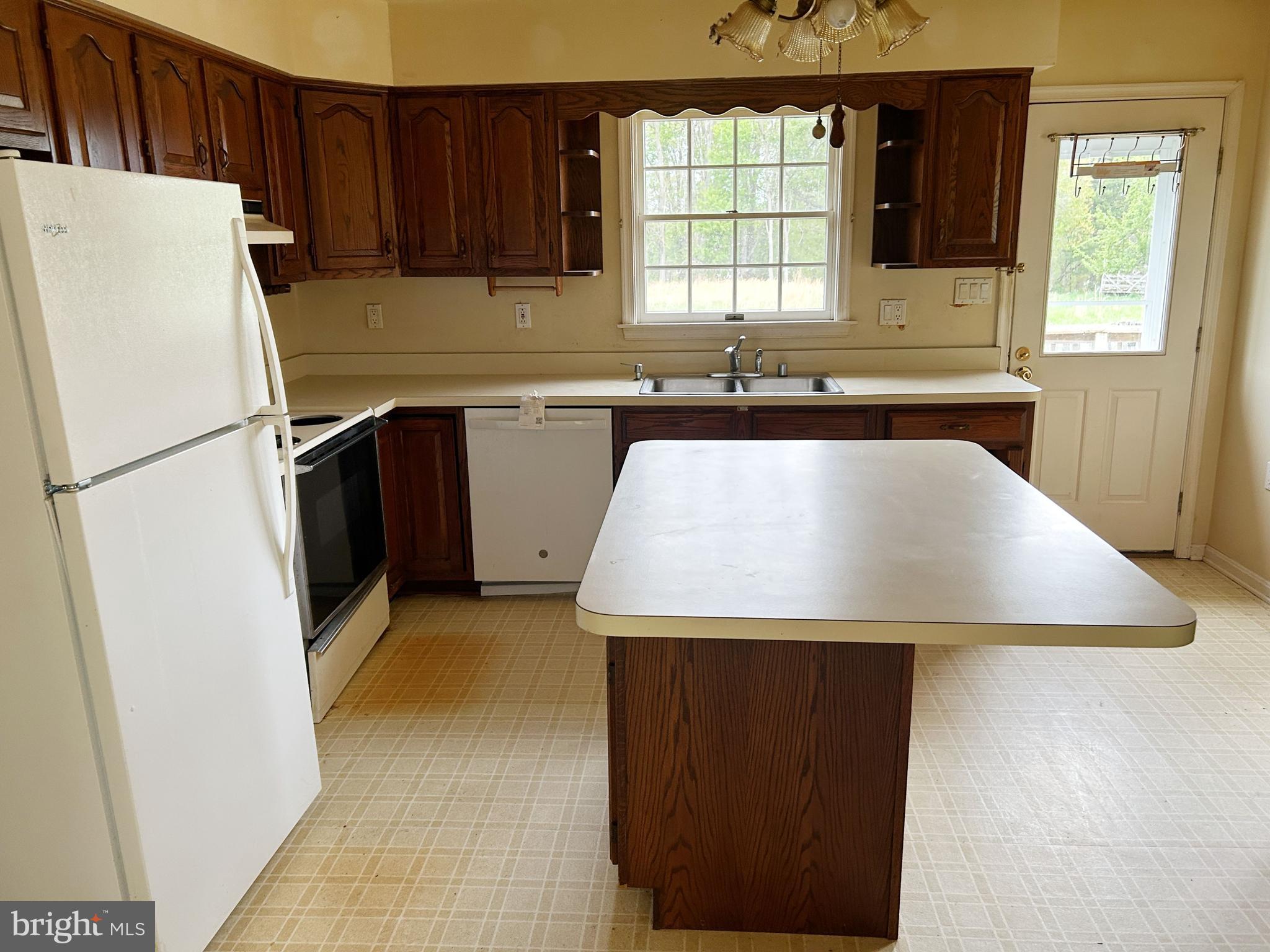 3832 Prospect Road Street, MD 21154 - Photo 9 of 21 a utility room with stainless steel appliances a refrigerator a sink a stove a microwave and cabinets