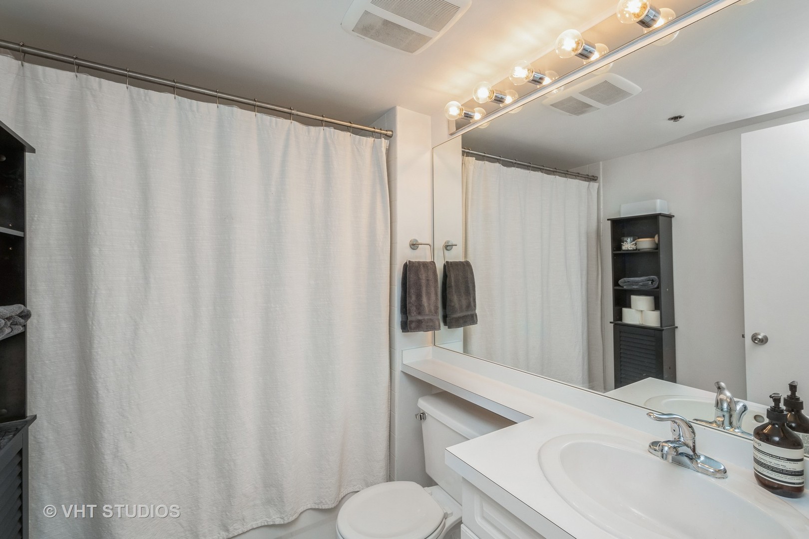 1601 South Indiana Avenue, Unit 407 Chicago, IL 60616 - Photo 11 of 16 a bathroom with a sink and mirror with toilet