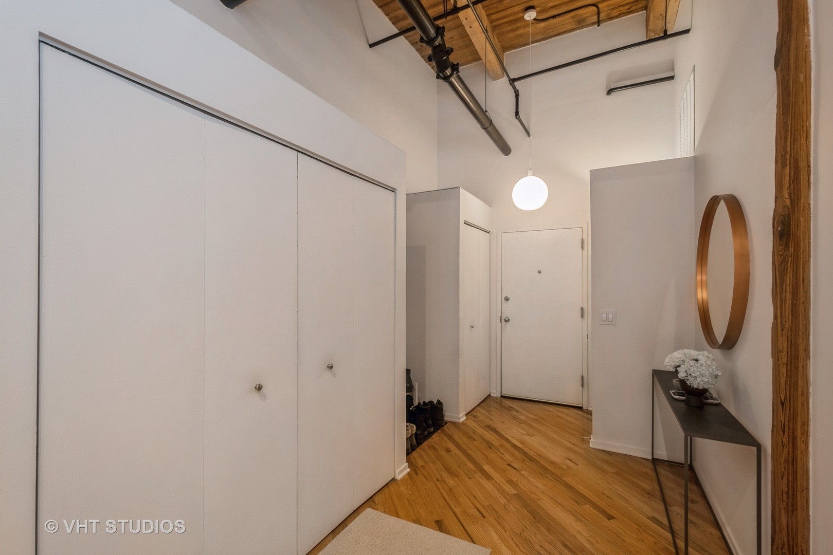 1601 South Indiana Avenue, Unit 407 Chicago, IL 60616 - Photo 13 of 16 a bedroom with a bed and a chandelier