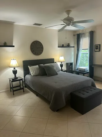 a bedroom with a bed and window