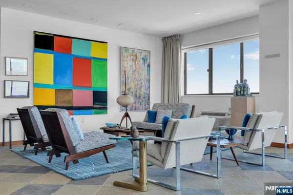 a living room with furniture a rug and a window