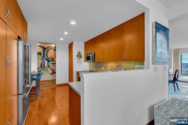 a kitchen with stainless steel appliances granite countertop a sink a stove and a refrigerator