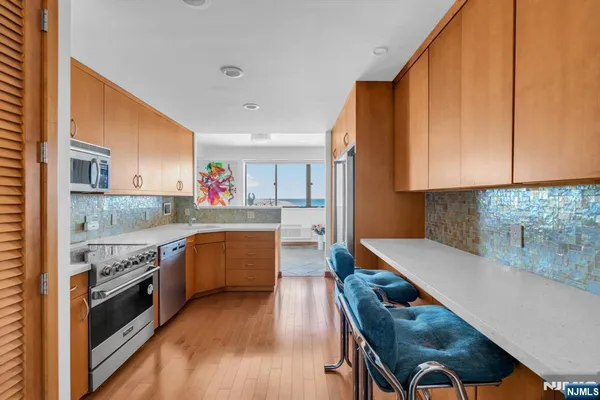 a kitchen with windows and refrigerator