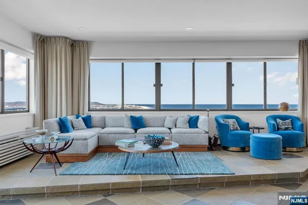 a living room with furniture and floor to ceiling window