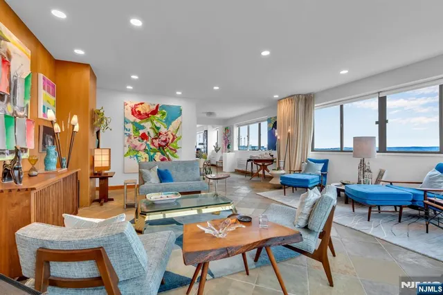 a living room with fireplace furniture and a potted plant