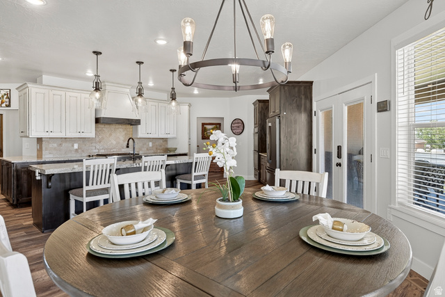 3311 West Allard Summit, UT 84772 - Photo 31 of 97 Open-concept dining area featuring a circular wood-finish table and a five-light chandelier
