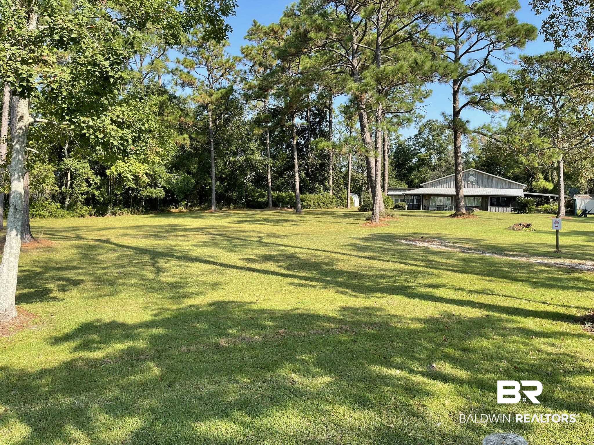 9202 Bay Pnes Road Elberta, AL 36530 - Photo 15 of 17 View of green lawn featuring view of scattered trees