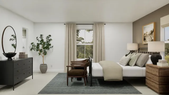 a living room with furniture a potted plant and a window
