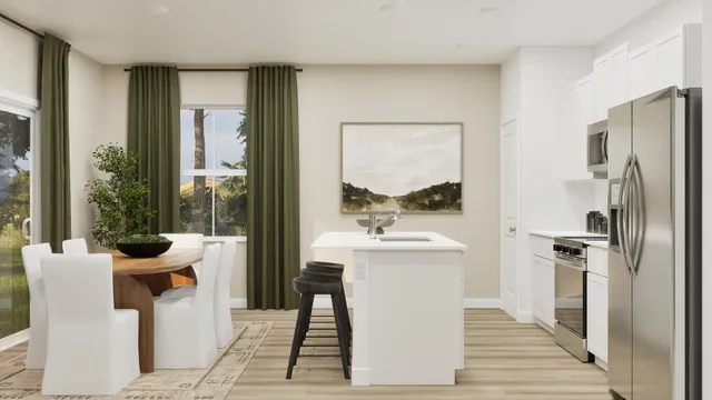 a dining hall with stainless steel appliances granite countertop a refrigerator and a sink