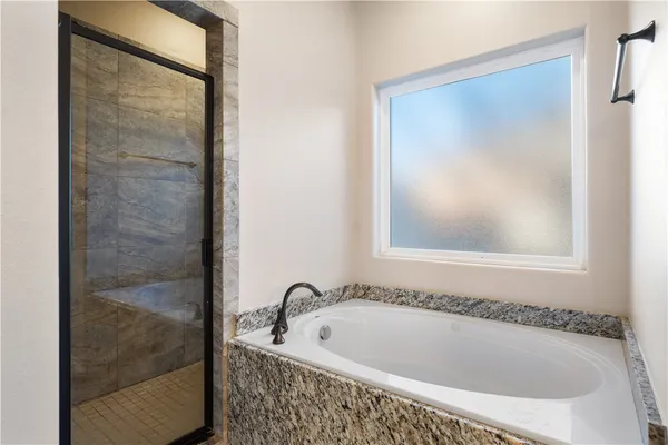 a bathroom with a tub and shower