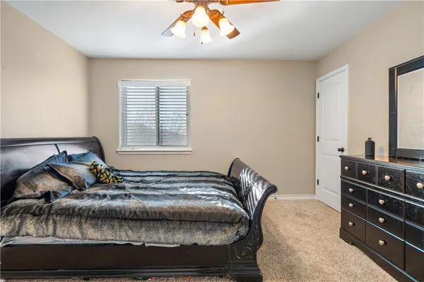 a bedroom with a bed and a dresser