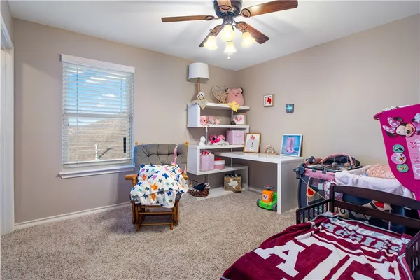 a bedroom with bed and a chandelier