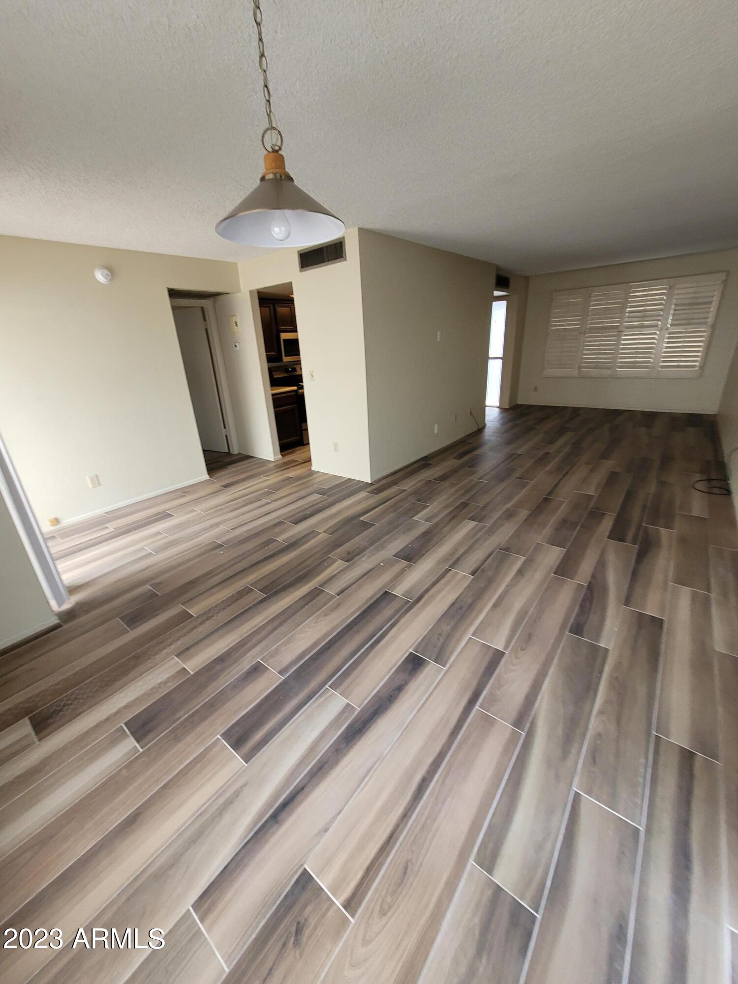 750 East Michelle Drive Phoenix, AZ 85022 - Photo 3 of 7 a view of a livingroom with wooden floor and staircase