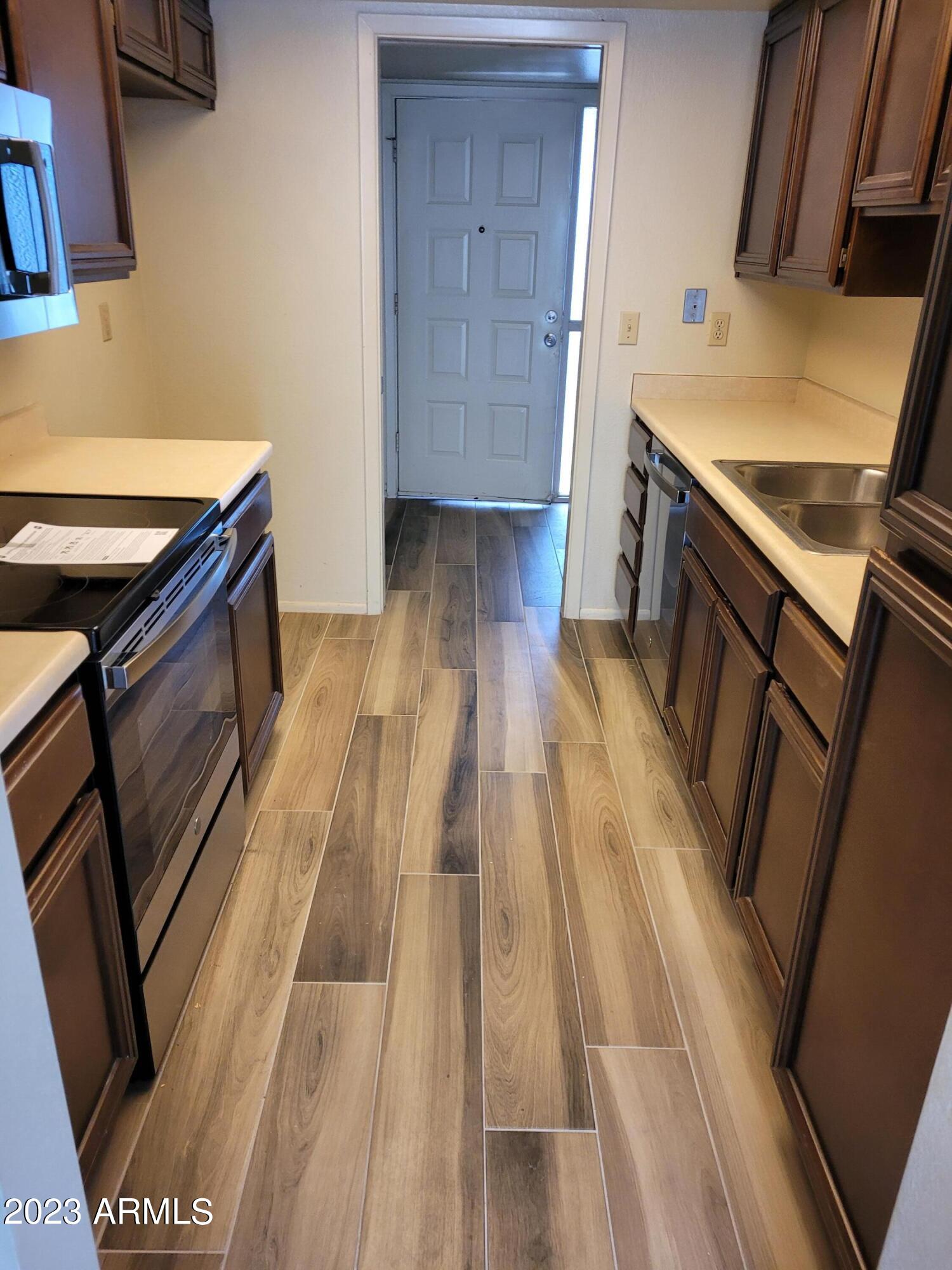 750 East Michelle Drive Phoenix, AZ 85022 - Photo 4 of 7 a kitchen with wooden floor and a sink