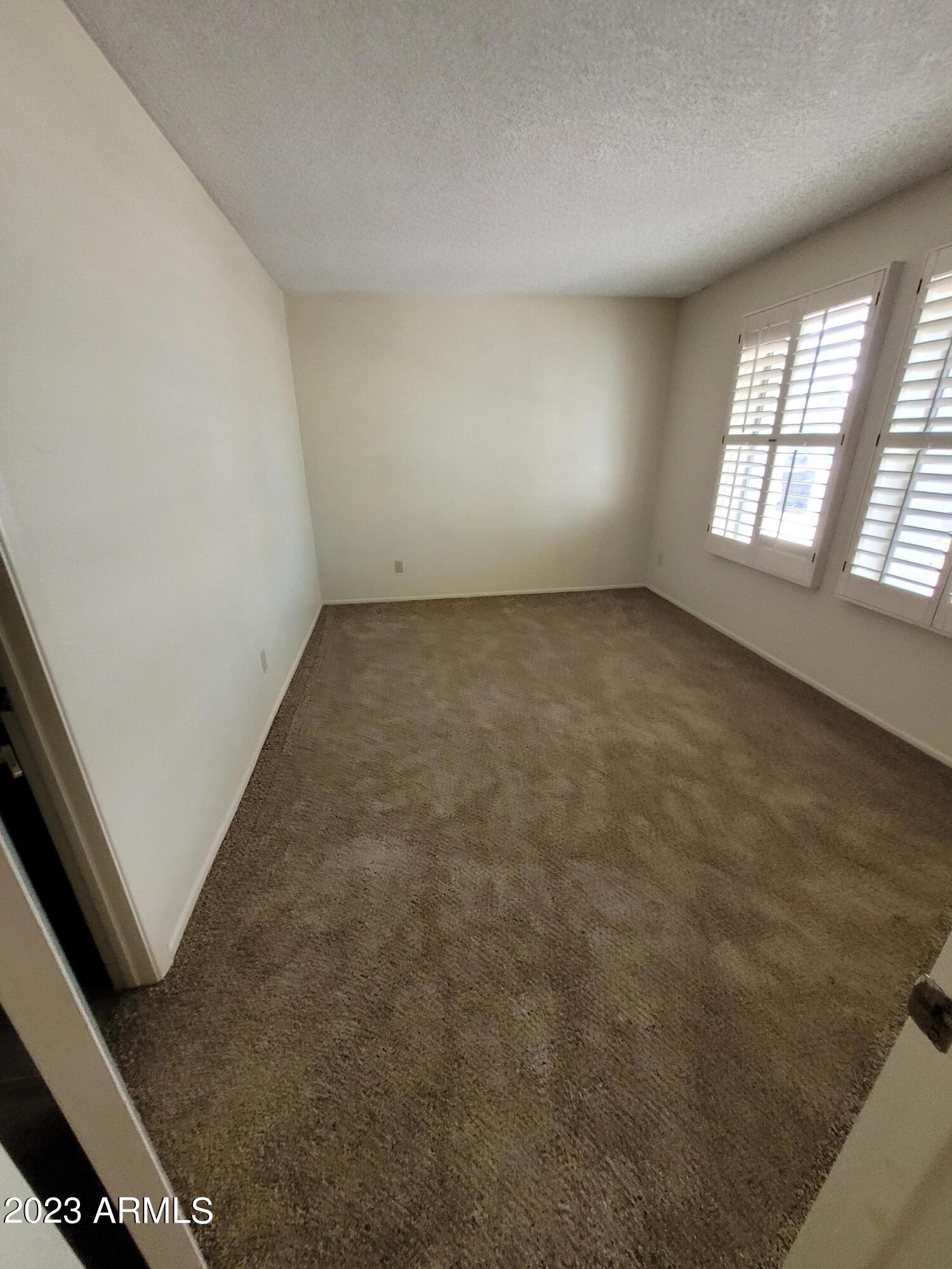 750 East Michelle Drive Phoenix, AZ 85022 - Photo 5 of 7 an empty room with windows
