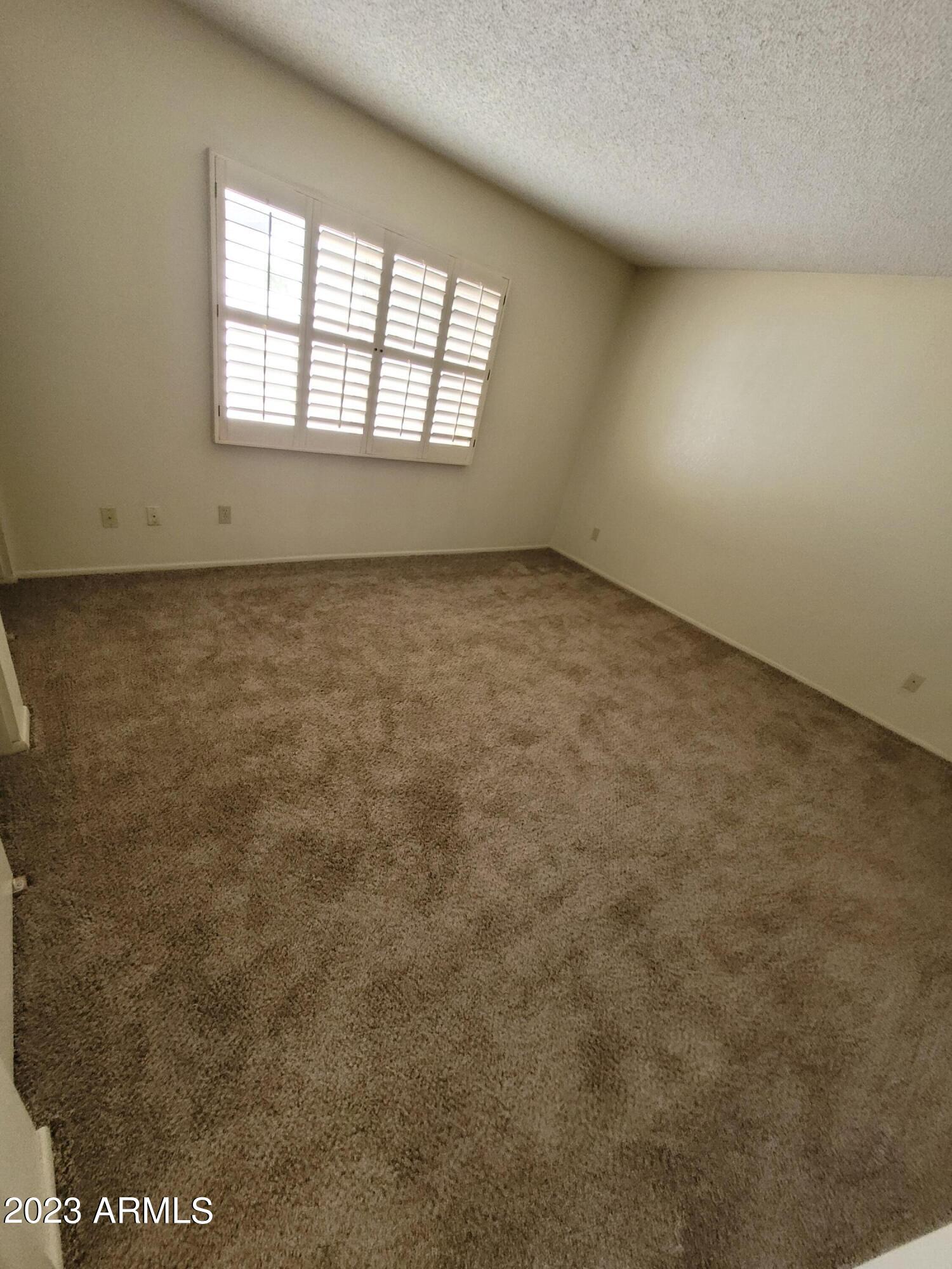 750 East Michelle Drive Phoenix, AZ 85022 - Photo 6 of 7 an empty room with a window