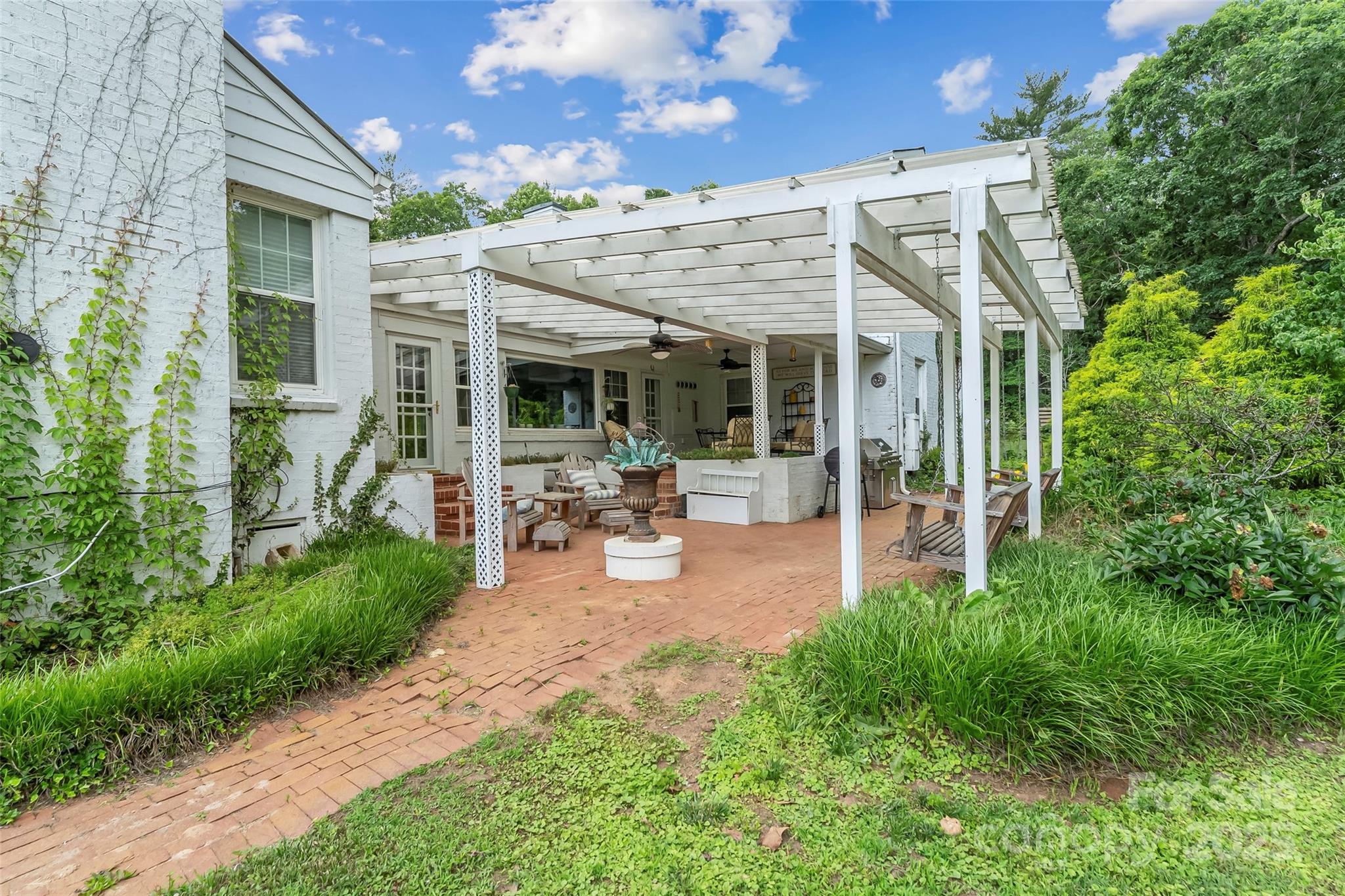 958 Highway 18 Morganton, NC 28655 - Photo 29 of 44 a view of a patio with table and chairs potted plants and large tree