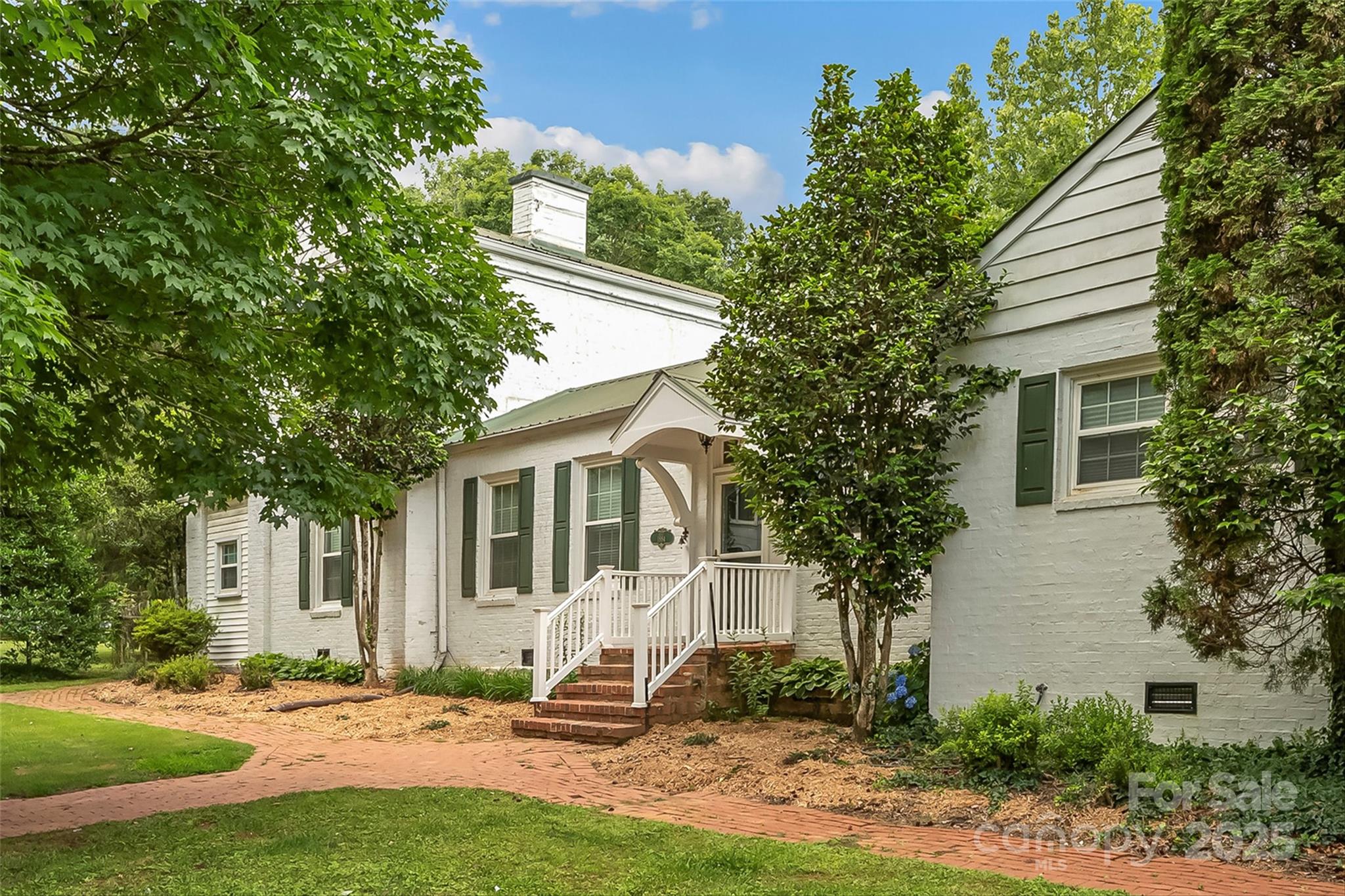 958 Highway 18 Morganton, NC 28655 - Photo 3 of 44 a front view of a house with garden