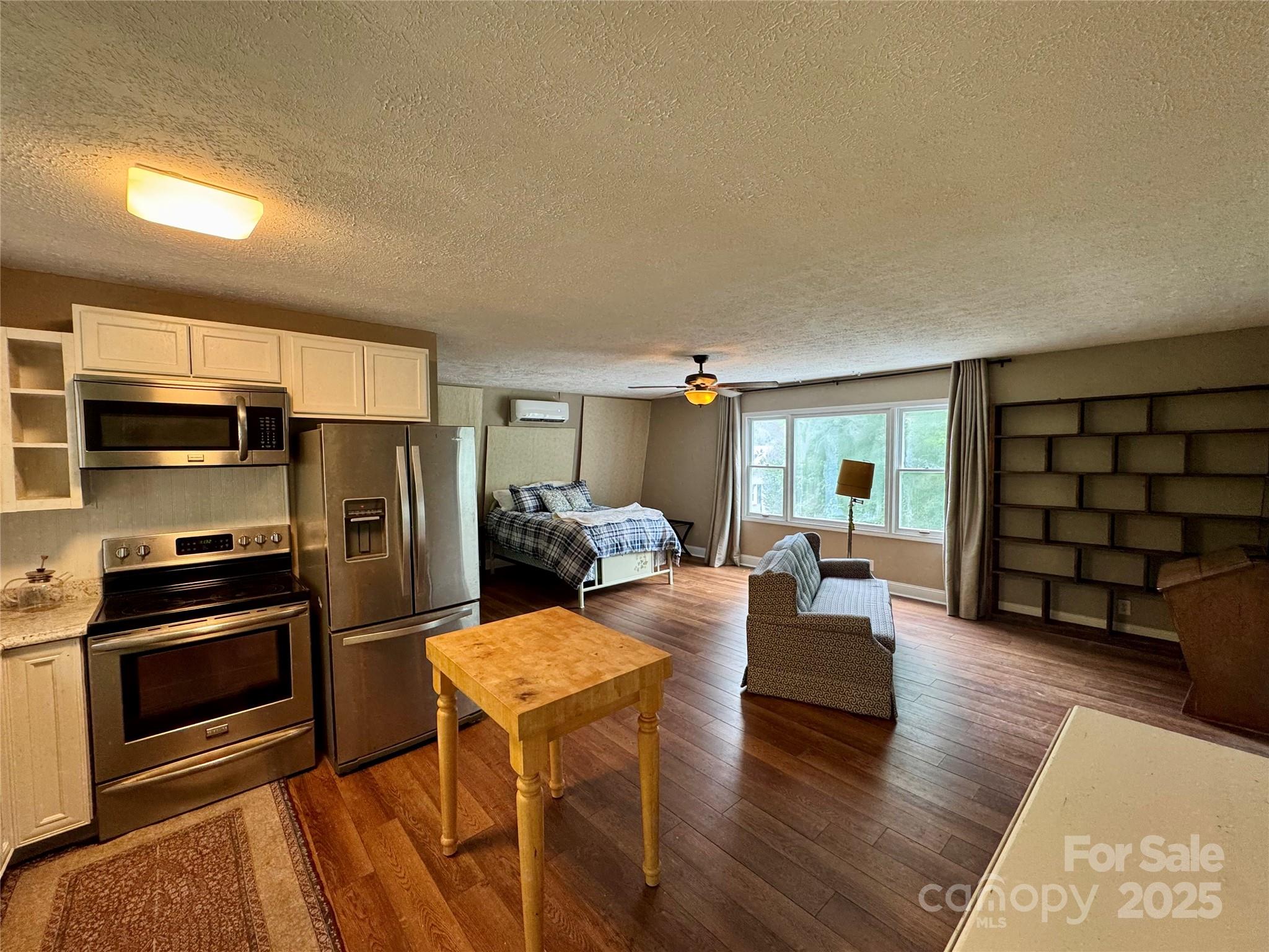 958 Highway 18 Morganton, NC 28655 - Photo 32 of 44 a living room with furniture a flat screen tv and kitchen view