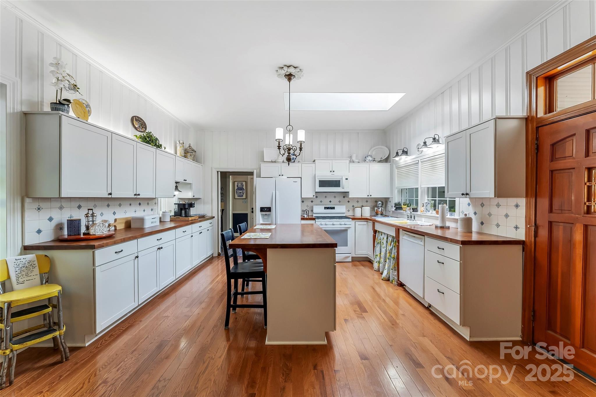 958 Highway 18 Morganton, NC 28655 - Photo 7 of 44 a kitchen with stainless steel appliances a dining table chairs sink and cabinets