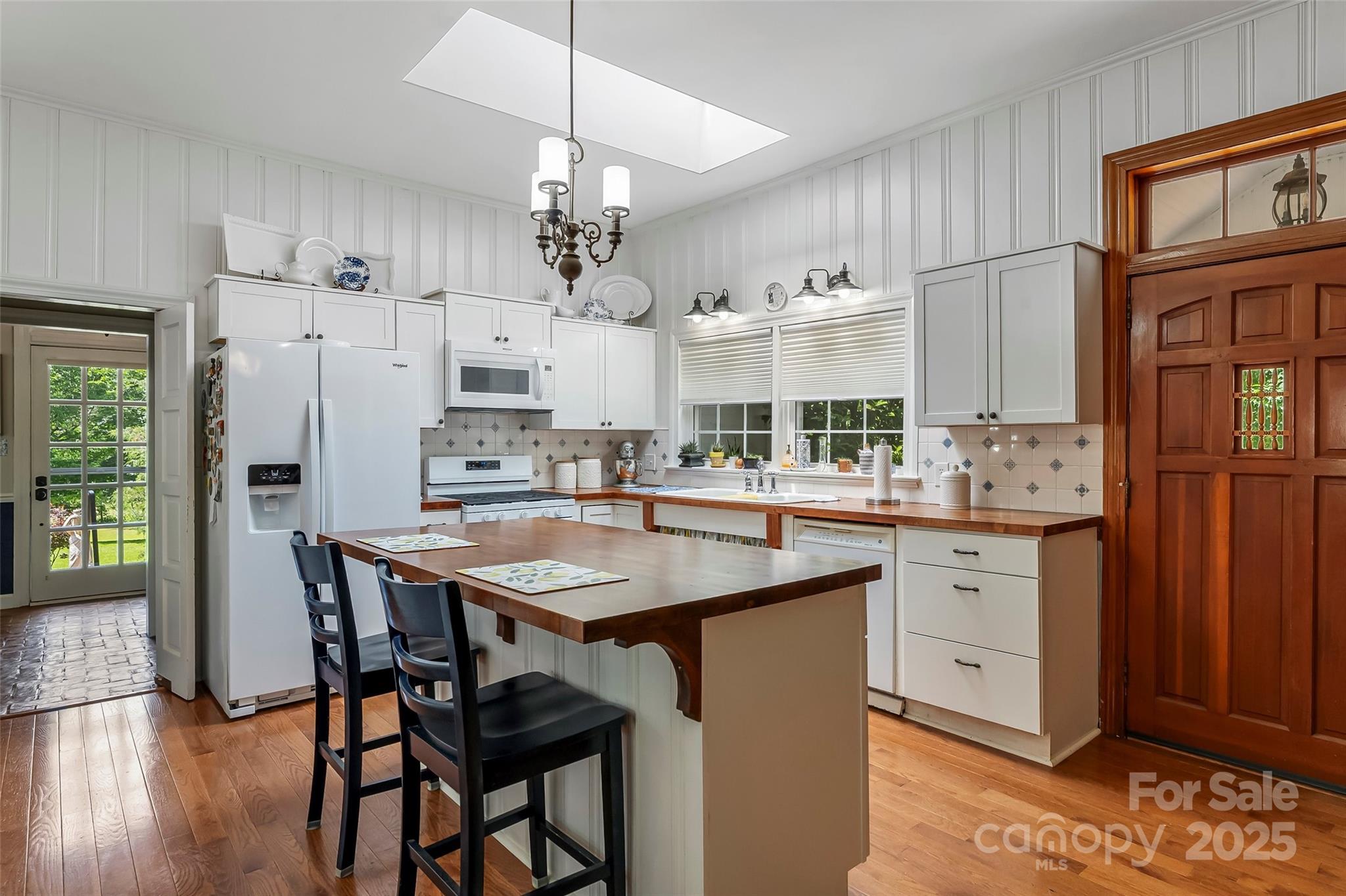 958 Highway 18 Morganton, NC 28655 - Photo 8 of 44 a kitchen with stainless steel appliances kitchen island granite countertop a kitchen island a stove a table and chairs in it