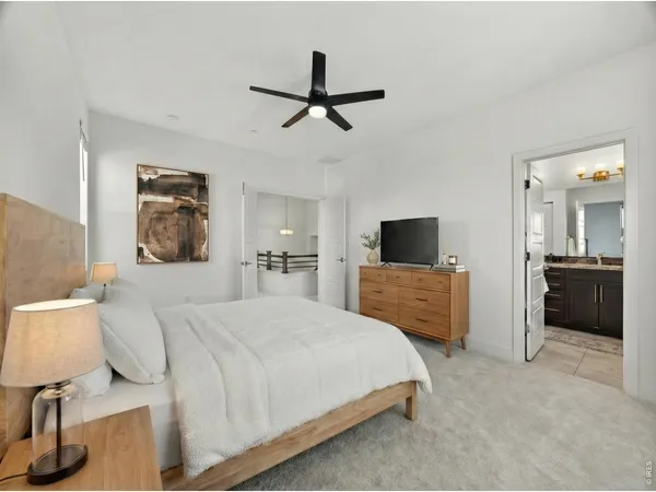 a bedroom with a bed and a television