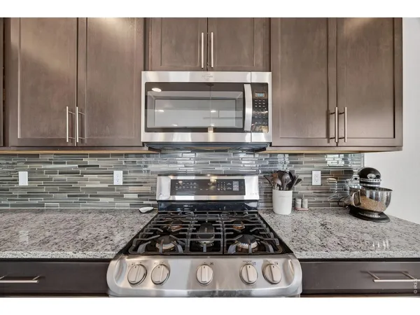 a kitchen with granite countertop cabinets and steel stainless steel appliances